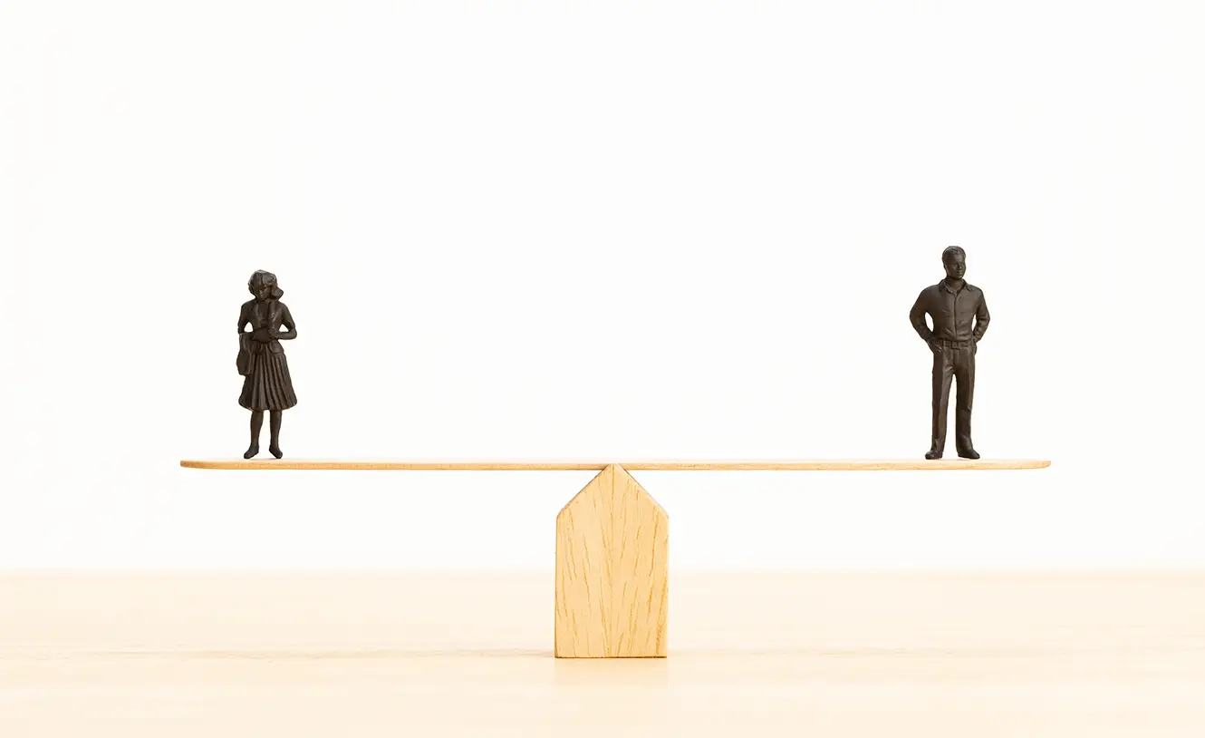gender-equality-concept-man-woman-figurine-seesaw-copy-space